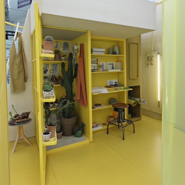 Minimal bedroom in yellow with loft bed as well as wardrobe and desk space underneath