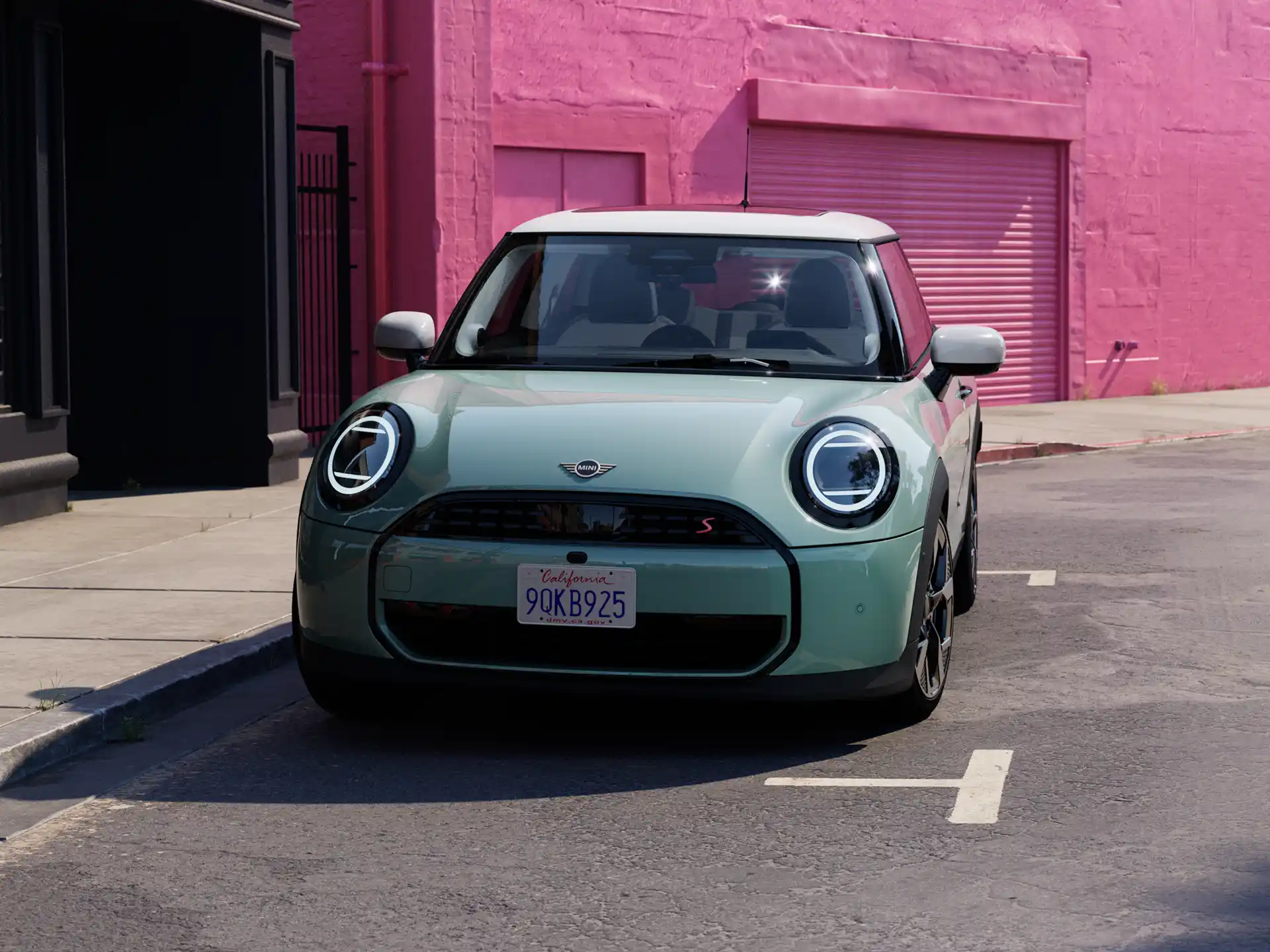 Collage of two pictures. On the left, the New MINI Cooper can be seen from the front. The car is standing on a purple circle in front of light blue background. Next to the car is a woman in a striking outfit. On the right picture, the moving New MINI Cooper can be seen.