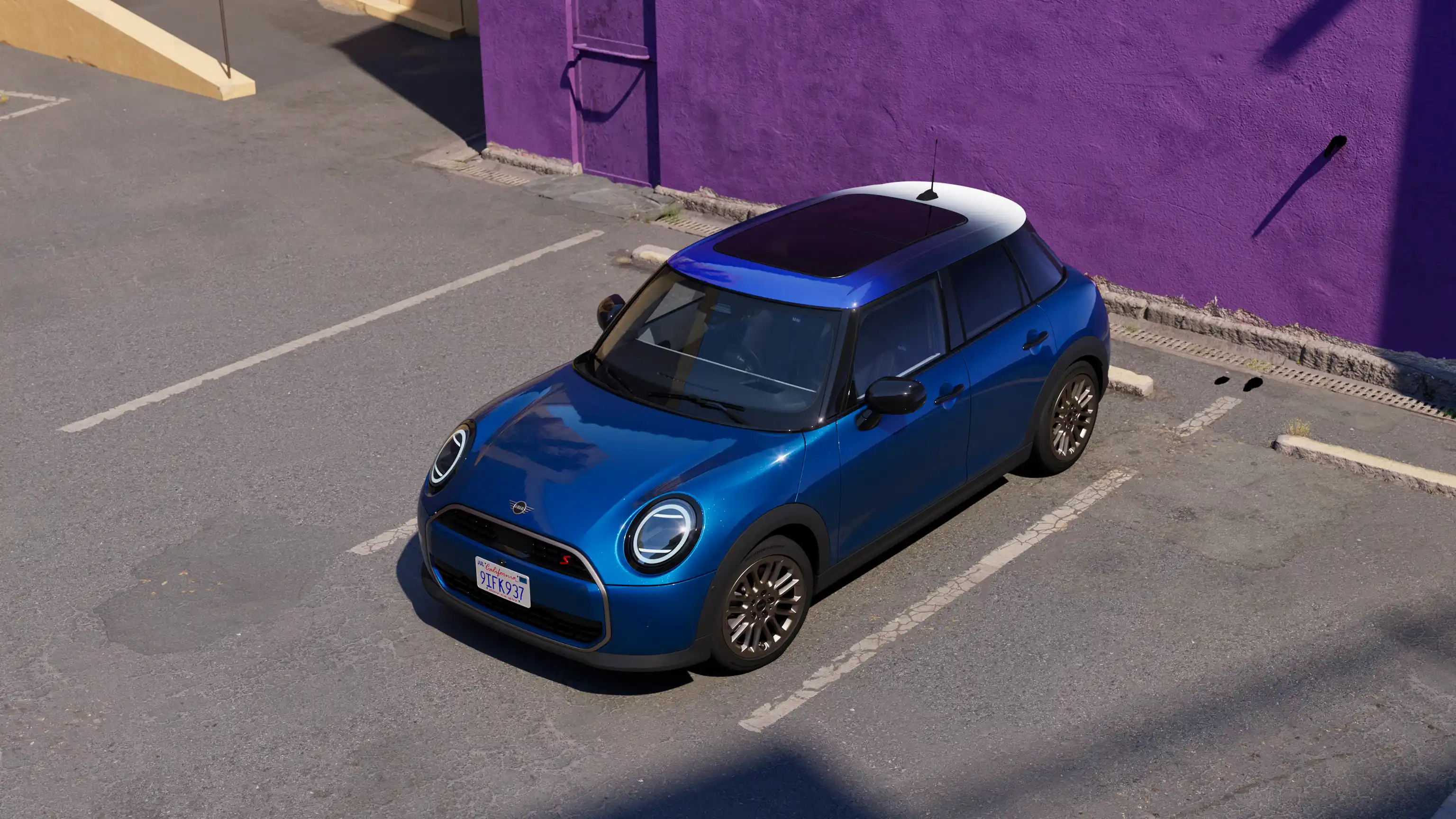 A woman with short blonde hair and colourful clothing smiles as she stands next to the new MINI Cooper 5-Door in Blazing Blue. Side profile of the new MINI Cooper 5-Door in Blazing Blue as it drives past a vibrant orange building in the city.