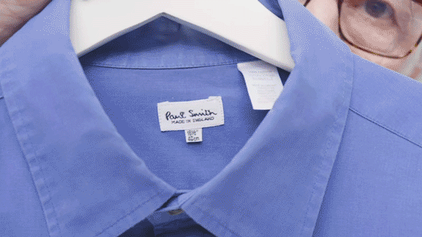 A gif with Paul Smith and a blue shirt in his hand, the colour template for his Paul Smith Edition model from 1998. 