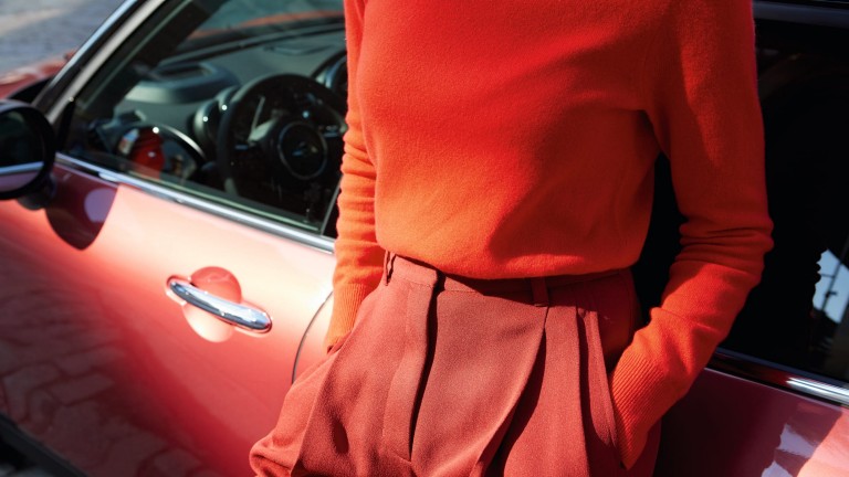 Woman leans against the MINI Clubman