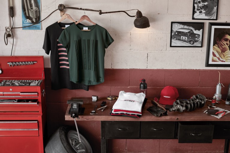 Lifestyle items displayed on a wooden table with red toolbox and vintage photo frames.