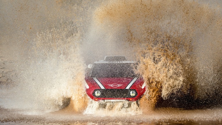 MINI John Cooper Works Buggy driving through water, sending spray in all directions at Dakar Rally 2018.