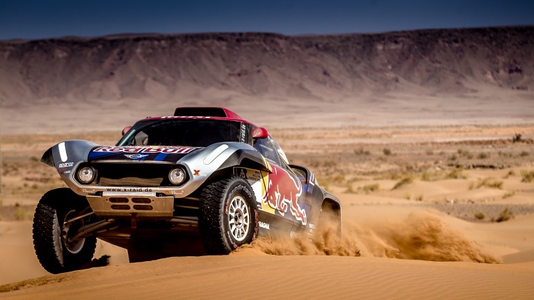 MINI John Cooper Works Rally driving up a sand dune at 2018 Dakar Rally.