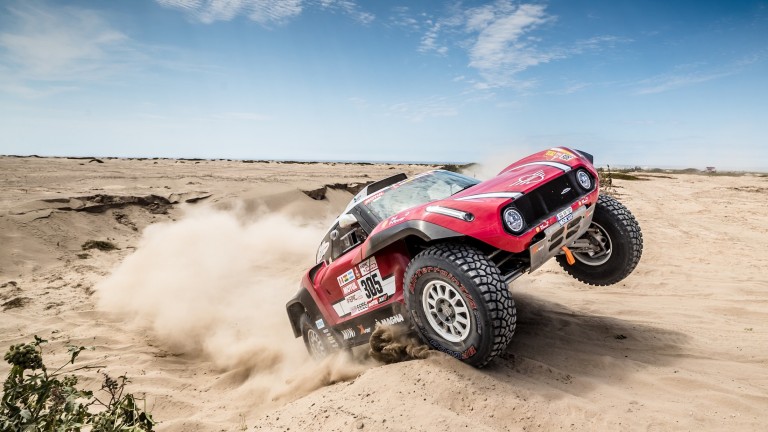 MINI John Cooper Works Buggy driving up a sand dune on its rear wheels at Dakar Rally 2018.