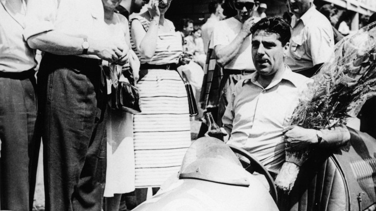 John Cooper, winner of Formula 3 race at Rouen, 1952, surrounded by onlookers.