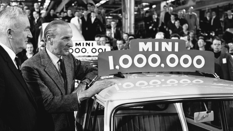 Sir Alec Issigonis standing next to the one millionth Mini.