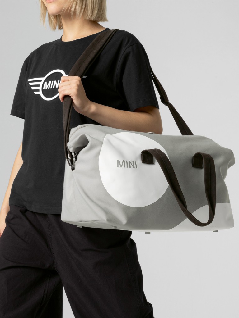 MINI car face detail duffle bag in grey and white with black straps.