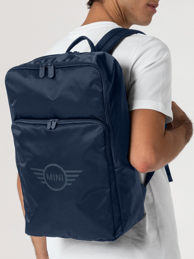 Deep blue MINI backpack with carrying handle, pockets with zippers and logo.