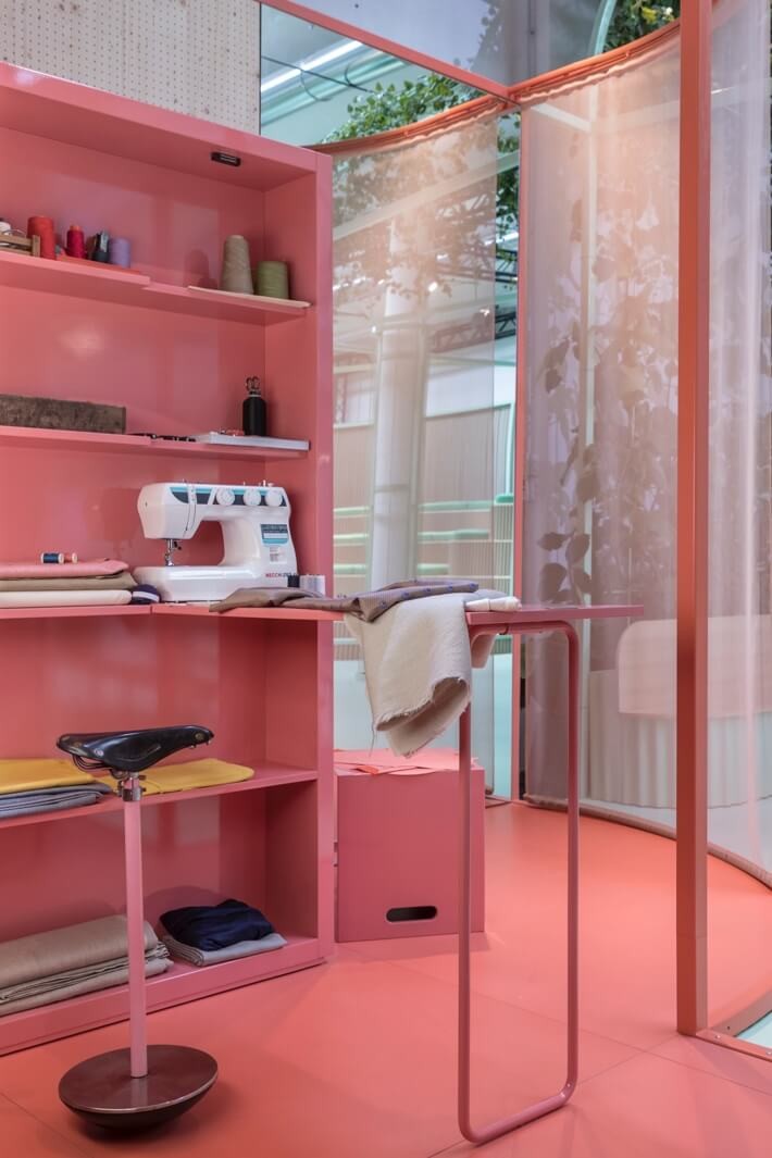 Little, pink sewing room with a bicycle seat stool in the totem