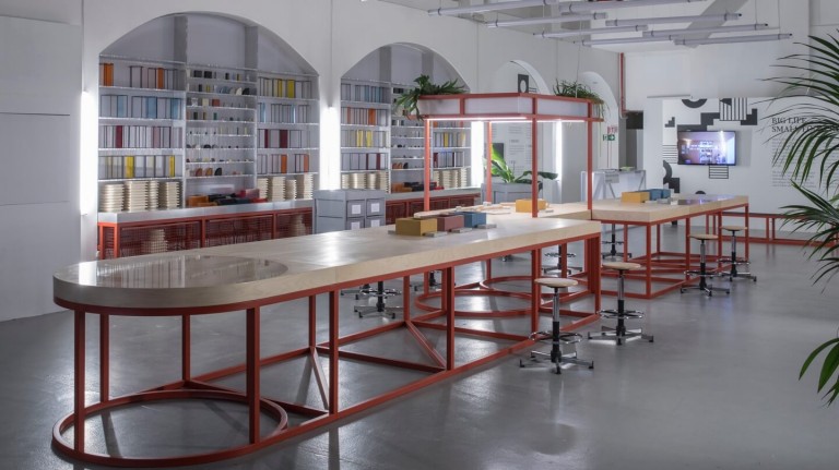 MINI's FACTORY OF IDEAS featuring long tables, stools, building blocks and other design materials