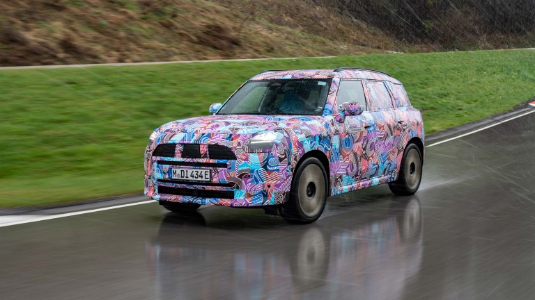 Front view of the new camouflaged MINI Countryman on the road.  