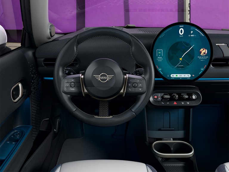 The steering wheel and parts of the dashboard of the New MINI Cooper.