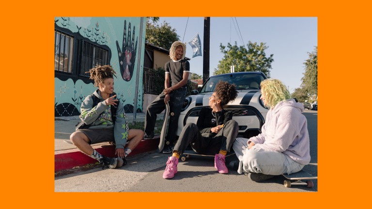 Briana King and her friends relaxing in front of her MINI Cooper S.