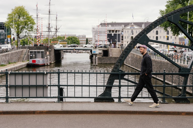 Alexis Christodoulou walks across a bridge that lead’s over one of Amsterdam’s canals.