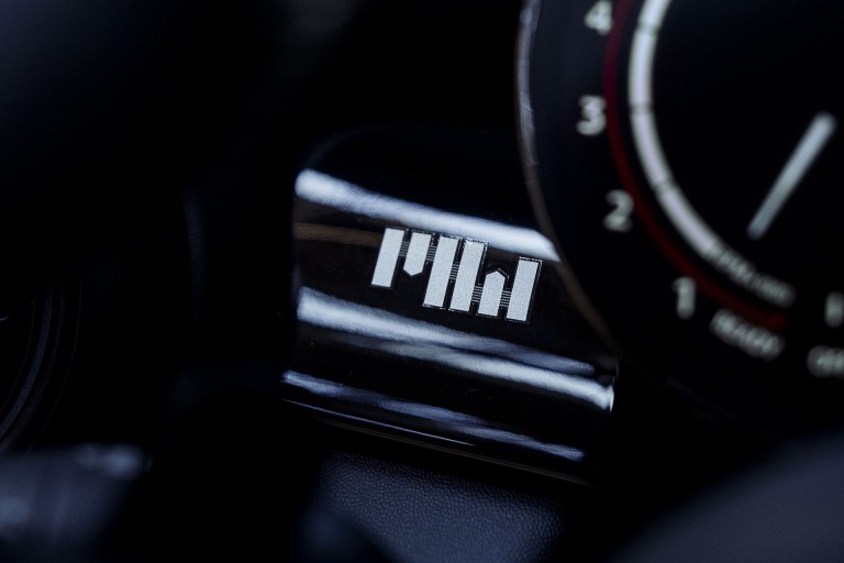 Close up of the driver’s side dashboard that underlines the motorsport engagement of the two legendary female drivers, reminiscent of an “M“ and a “W“ - representing “Moss“ and “Wisdom”. 