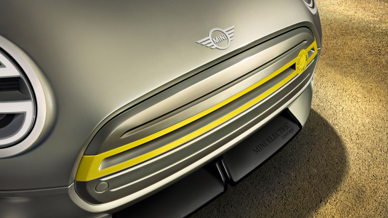 Grille of a silver Mini Electric Concept car with a yellow flourish.