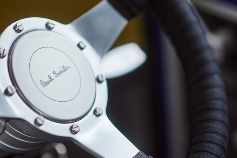 Close-up of the redesigned and removable steering wheel with Paul Smith’s signature. 