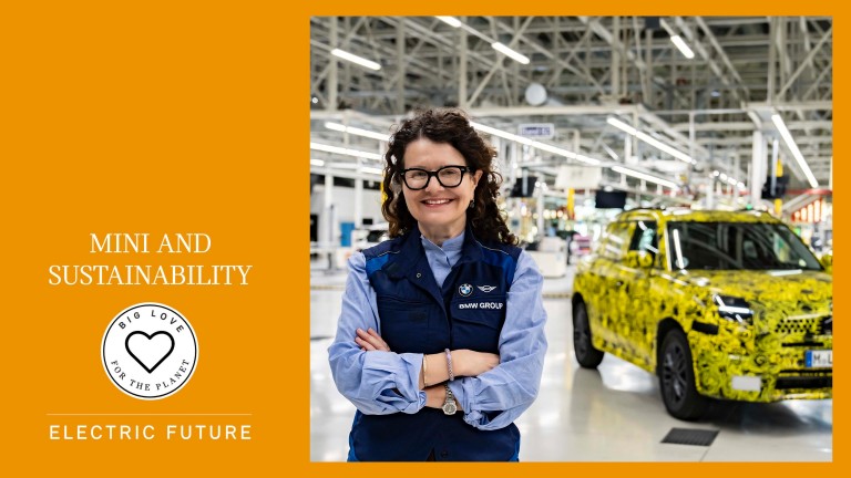 Image of Stefanie Wurst, head of MINI, standing next to the new MINI Countryman in the BMW Group factory hall in Leipzig. 