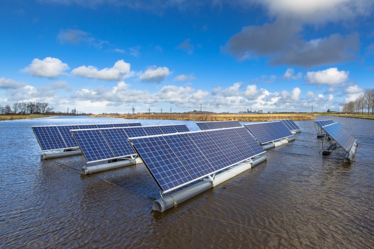 A photo of floating solar panels on open water.