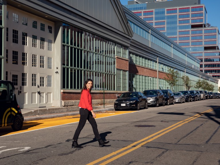 Miriam Roure crosses the street in front of the historical Newlab building in the Brooklyn Navy Yard, where URBAN-X is based. 
